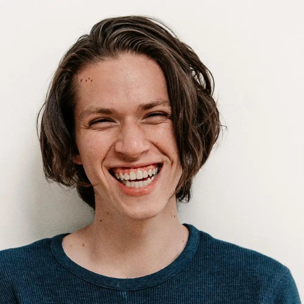 Person with short brown hair smiling against a plain background. Image credit: NRD