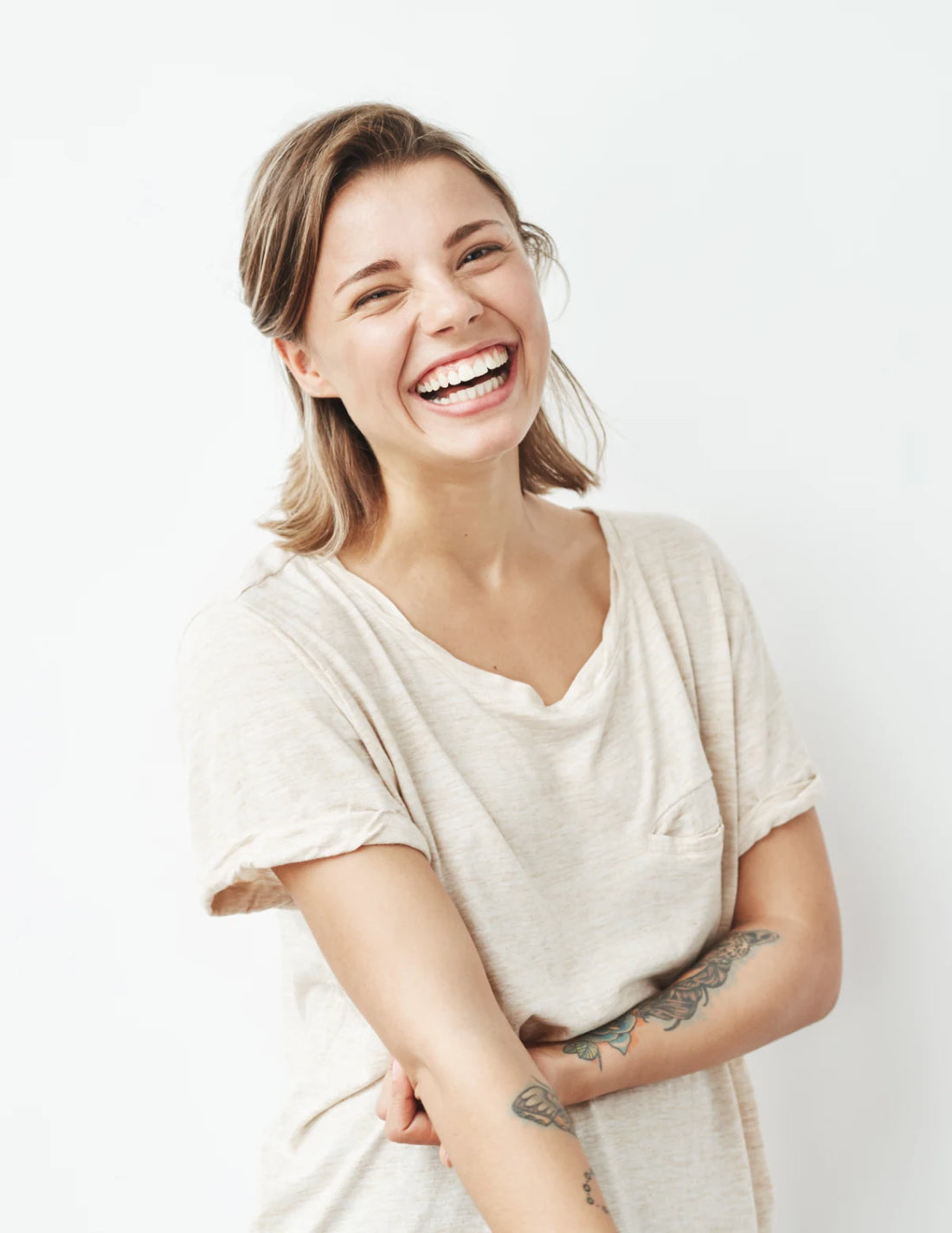 Woman wearing a white t-shirt against a plain background