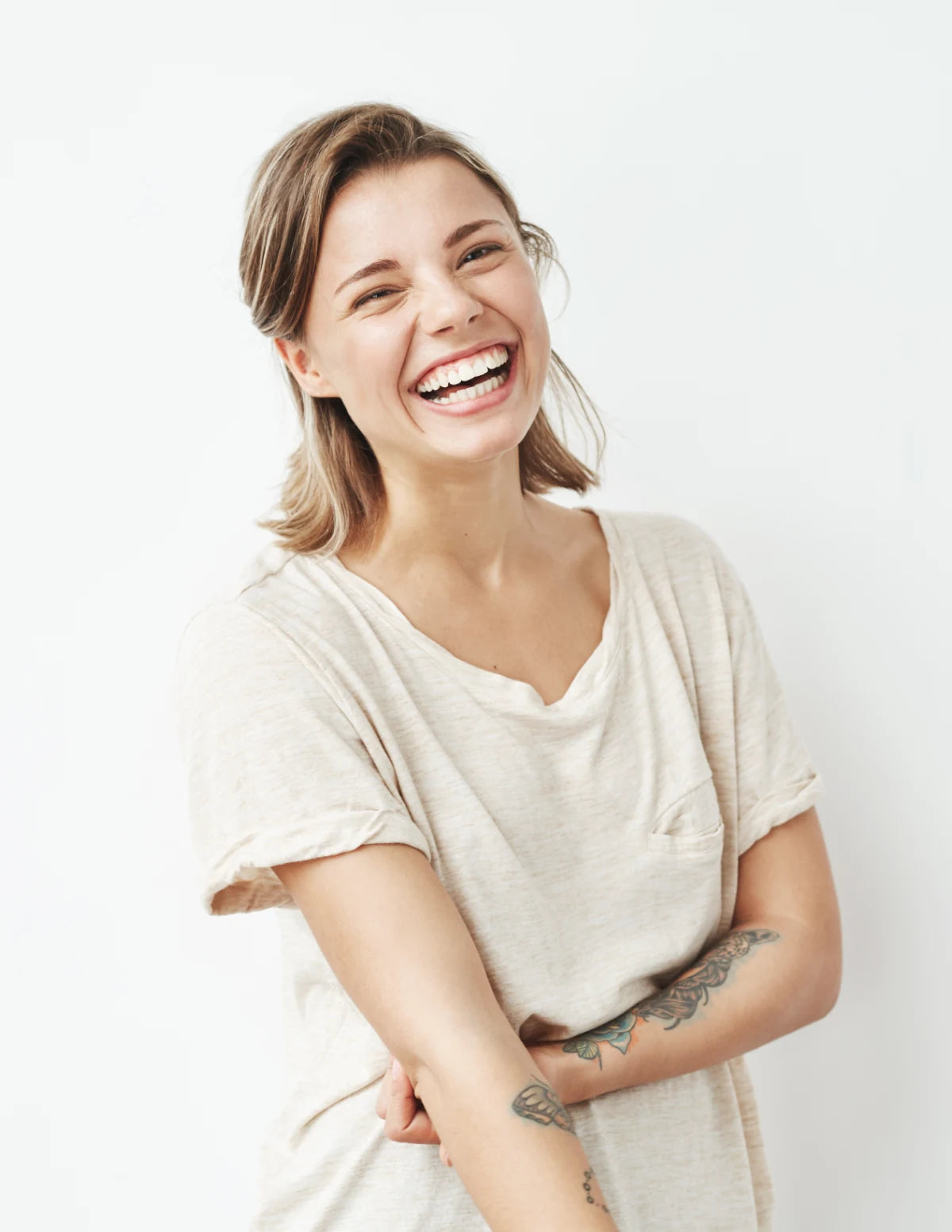 Woman wearing a white t-shirt against a plain background