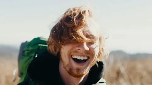 Happy backpacker in nature with smile. Photo credit: Mike Baker