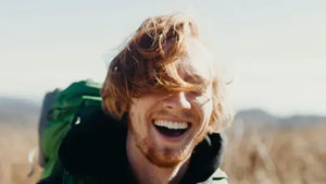 Happy backpacker in nature with smile. Photo credit: Mike Baker